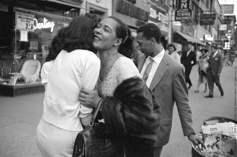 Billie Holiday embraces a fan on Broad Street after receiving a gift, Carl Drinkard is behind her flicking his cigarette © 2018 Jerry Dantzic/ Jerry Dantzic Archives. All rights reserved.
