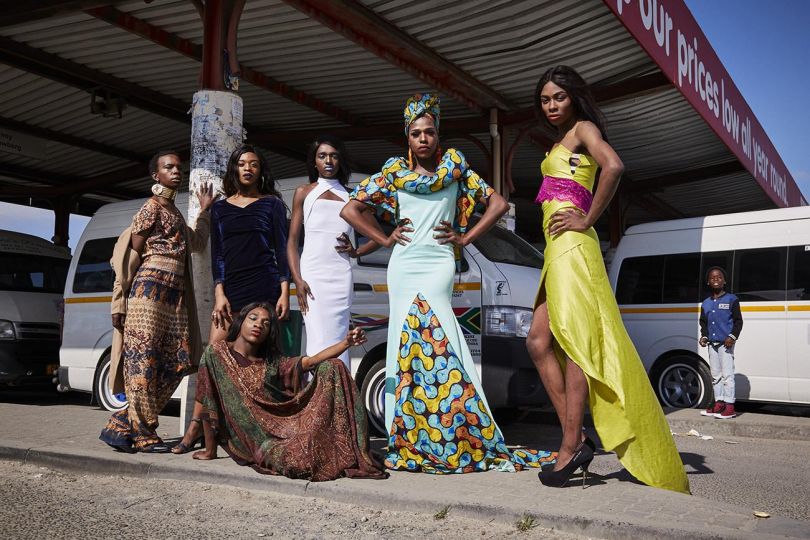 The team of #blackdragmagic pose for a group shot at the taxi rank in site C Khayelitsha. This is done as an act of activism to reclaim the township and to stand up against the overwhelming climate of discrimination members of the LGBTQI+ community face in the township. With this portrait the group intends to send a clear message that public and community spaces need to be safe spaces for members of the LGBTQI+ community. Aug. 4, 2019.  © Lee-Ann Olwage - Courtesy Bonne Espérance Gallery