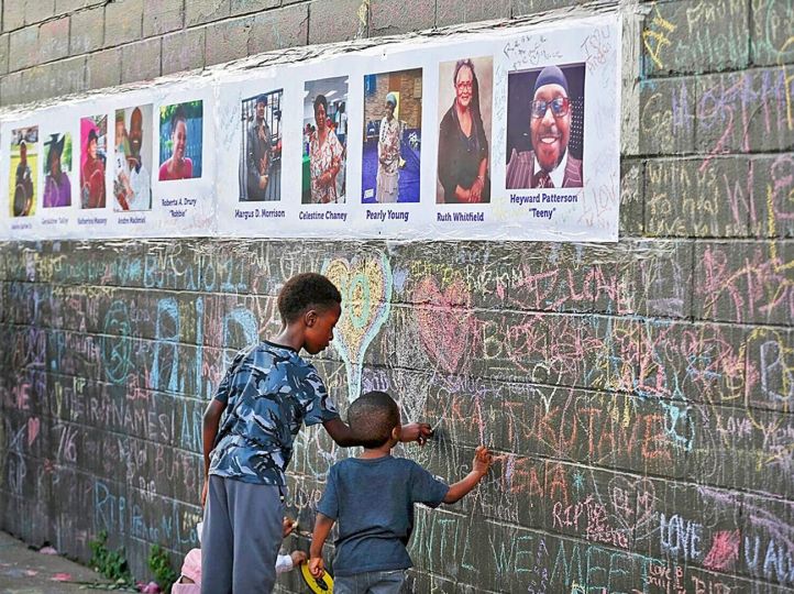 © Sharon Cantillon. Children Writing on Memorial Wall, May 20, 2022. The Buffalo News.