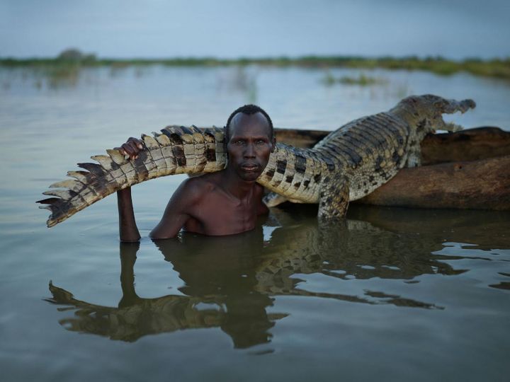 Mories, a Dies subsistence hunter and fisherman, with nile crocodile. Dassanach Nation, Lake Turkana, Southern Nations, Nationalities, and People's Region, September 2020 © Joey L – Courtesy Earth Aware/Simon & Schuster 