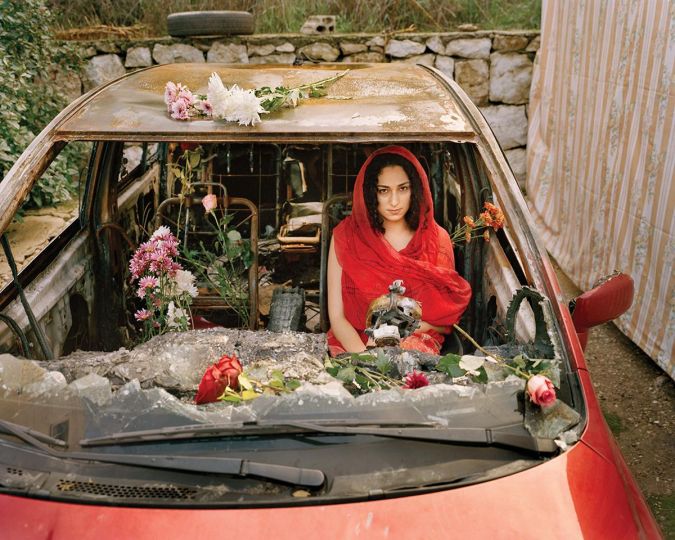 Farah in Her Burnt Car, Aabey, Lebanon, 2019 © Rania Matar- Courtesy of the artist and Fitchburg Art Museum