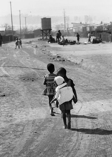 Ernest Cole - South Africa, 1960s. With older children in school and mothers at work, baby baby- minders are a common sight on African township streets. From the chapter „Below Subsistence“ © Ernest Cole / Magnum Photos