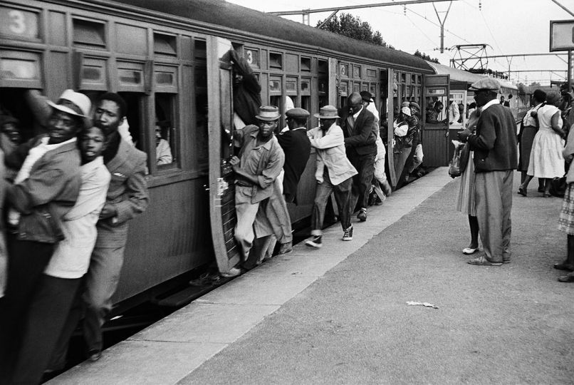 Ernest Cole - South Africa, 1960s. Africans throng Johannesburg station platform during late afternoon rush hour. Whistle has sounded, train is moving, but people are still trying to get on. From the chapter „Nightmare Rides“ © Ernest Cole / Magnum Photos