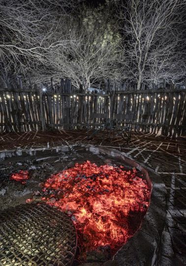 Coals from a few Leadwood logs glow red till late into the African night. Leadwood wood is considered to be one of Africa's hardest woods, and a fire made from this wood will burn for hours. © Obie Oberholzer