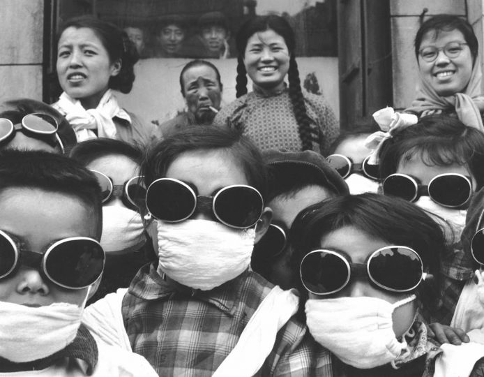 Schoolgirls wearing face masks and goggles (to protect them from sand from the Gobi Desert), China, 1957 © Agnes Varda Estate, courtesy of FaheyKlein Gallery, Los Angeles