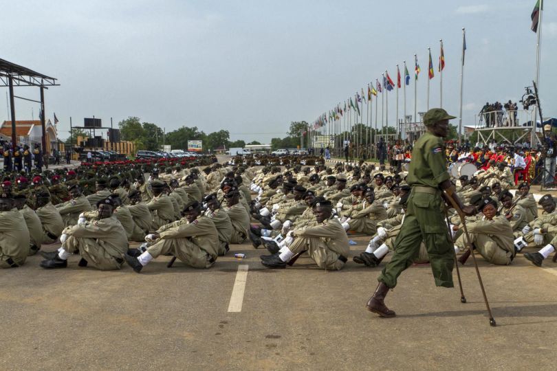 A soldier who lost his leg during the war against Sudan passes by soldiers during the 7th anniversary of Martyrs' day on July 30, 2012 in Juba. For the second time since the secession from Sudan, South Sudanese came to commemorate the 7th anniversary of Martyrs' day in rememberance of the soldiers who lost their life during the war against Sudan. AFP PHOTO / Camille Lepage (Photo by CAMILLE LEPAGE / AFP) - Courtesy Manuel Rivera-Ortiz Foundation