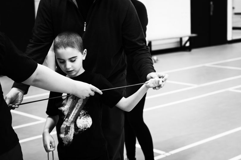 At fencing training for blind, Montreal (Canada), December 2nd 2023. Gabriel (8 years old) has been blind since birth. He attends youth fencing training for the blind provided by the Quebec Association of Blind Sports. The coach takes the time to introduce him to the equipment before moving on to practice. © Ophélie Chauvin