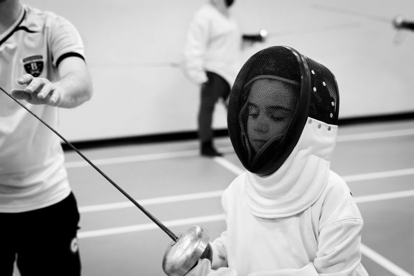 At fencing training for blind, Montreal (Canada), December 2nd 2023. Gabriel (8 years old) has been blind since birth. He attends youth fencing training for the blind provided by the Quebec Association of Blind Sports. The coach takes the time to introduce him to the equipment before moving on to practice. © Ophélie Chauvin