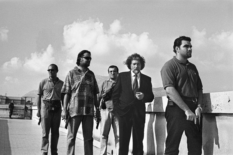 Magistrate Roberto Scarpinato with his escort on the roofs of the Court. (Il magistrato Roberto Scarpinato con la sua scorta sui tetti del Tribunale.) Palermo, 1998 © Courtesy Archivio Letizia Battaglia and The Photographers' Gallery