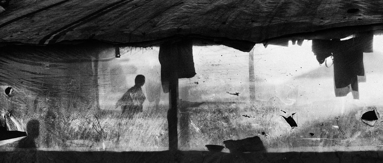 Kabul, Afghanistan, February 2019: The winter afternoon sun enters a tent in Hussain Khail informal settlement on the outskirts of Kabul. Most camp inhabitants are from the northern province of Kunduz. Intense fighting between the Taliban and the Afghan Army forced them out of the area. Every family has a harrowing war story, many have been injured in the crossfire or lost family members in the fighting. © Lorenzo Tugnoli