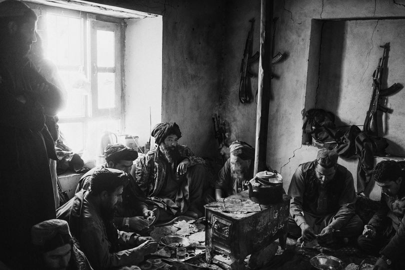 Nangarhar, Afghanistan, December 2019: A group of Taliban fighters in a house used as a hideout in the remote mountains of Khogiani district near the border with Pakistan. Taliban fighters used areas near the border to control the smuggling routes and have access to the neighbouring nation to regroup and resupply. © Lorenzo Tugnoli