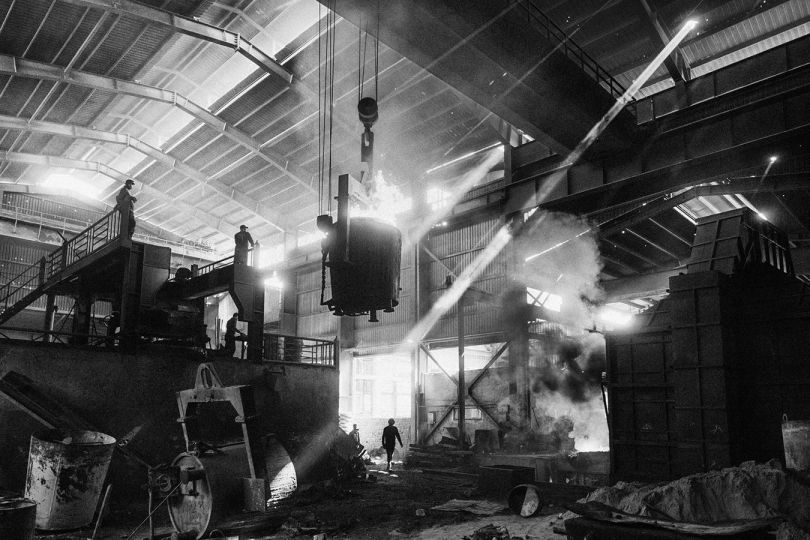Kabul, Afghanistan, May 2023: Factory workers operate a crane inside the Chinese-owned Faqiri steel mill. After the Taliban takeover and the US withdrawal in 2021, China’s trade interests in Afghanistan grew. Many Chinese business people travelled to Afghanistan to try their fortune and the Chinese state has conducted talks with Taliban authorities over mining concessions, including lithium. © Lorenzo Tugnoli