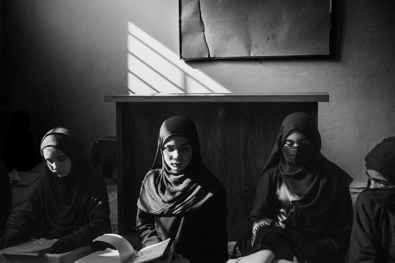 Kabul, Afghanistan, October 2022: Students attend a class in a madrassa. Since the Taliban government banned girls from attending regular schools, an increasing number of girls are enrolling in madrassas or religious schools where they memorise and learn to recite Islamic scriptures. © Lorenzo Tugnoli